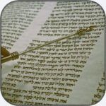 Hand with Yad on Torah Scroll